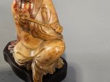 a figurine of a man sitting on a rock