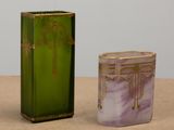 pair of green and purple vases sitting on top of a table