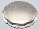 a silver plate with a circular design on it