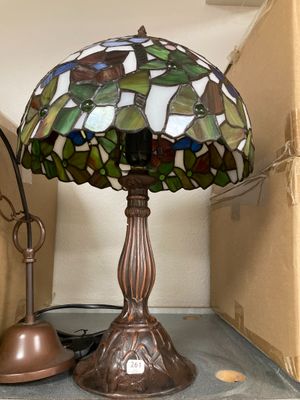 a lamp that is sitting on a shelf next to a lamp