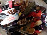 many pairs of shoes in a bag on the floor