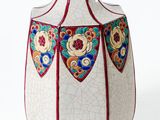 a white vase with a red base on a white background
