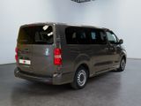 a van that is parked in a room with a ceiling fan