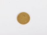 a gold coin on a white surface with a white background