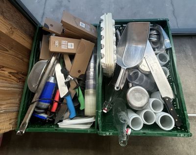 a green container filled with assorted kitchen utensils
