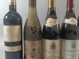 several bottles of wine are lined up in a row on a table