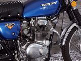 a blue motorcycle that is parked in a parking lot