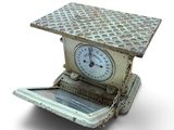 a small scale with a clock on top of it