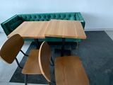 a table with two chairs and a bench in a room