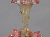 a glass vase with pink flowers in it on a table