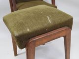 a chair with a green seat and a wooden foot rest
