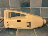 an image of a white hand held vacuum cleaner on a tiled floor