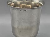 a silver cup on a pedestal on a grey background