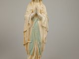 statue of a woman holding a rosary in her hands