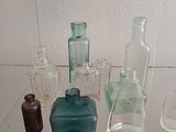 many glass bottles on display in a glass case