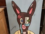 a sign with a picture of a donkey with a face painted on it