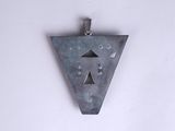 a metal triangle with holes in it on a white wall