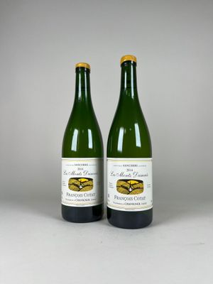 two bottles of wine sitting next to each other on a table