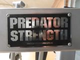 a sign that says predator strength on the back of a bike