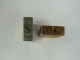 two pieces of metal that are on a white surface