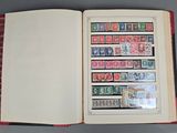 an open book with stamps on it sitting on a table
