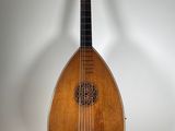an image of a mandolin sitting on a stand