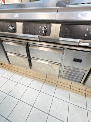 plusieurs cuisinières et fours en acier inoxydable dans une cuisine professionnelle