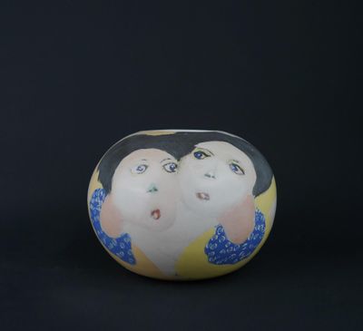an egg shaped like a woman ' s face on a black background