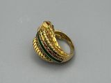 an image of a gold ring with green and red stones