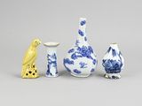 three blue and white vases and a bird on a gray background