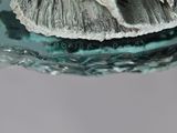 a close up of a glass plate with a piece of food on it