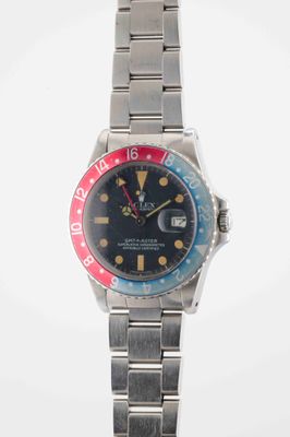an image of a wrist watch with a red, blue and yellow bezel