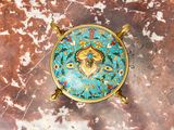 a blue and gold plate with a fish on it