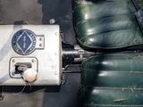 a close up of a seat with a remote control on it