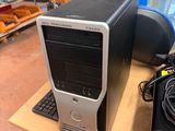 a desktop computer sitting on top of a wooden table