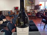 a bottle of wine sitting on a table in a restaurant