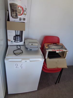 a small kitchen with a refrigerator, microwave, and a microwave oven