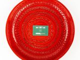 a red plate with a green label on it