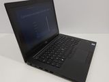 a black laptop computer sitting on a white table