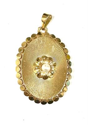 an image of a gold pendant with a flower in the center