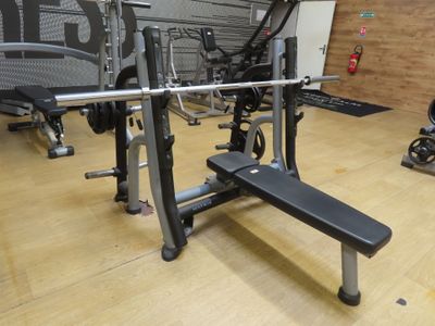 an image of a gym room with a bench, weights, and other equipment