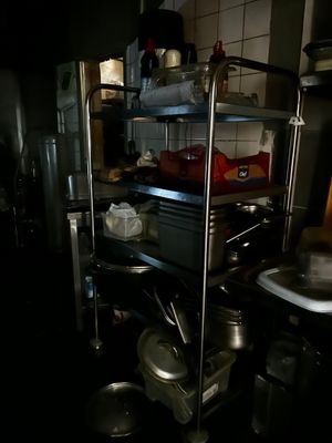 a kitchen with many pots and pans on the shelves
