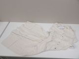 a white table with a white shirt and pants on it