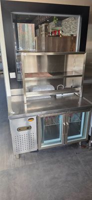a stainless steel counter with a sink and oven in it