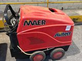a red machine that is sitting on the ground