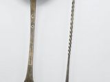 two spoons and a fork on a white surface