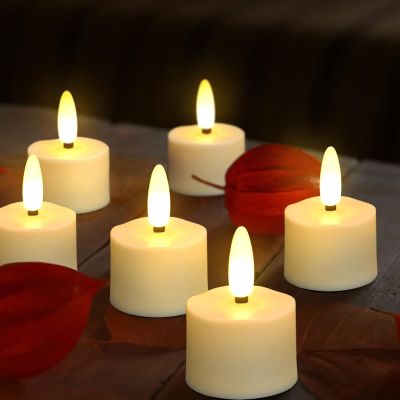 lit candles on a wooden table with leaves and a red rose