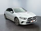 a white mercedes cla parked in a white room