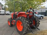 a red tractor that is parked on the side of the road