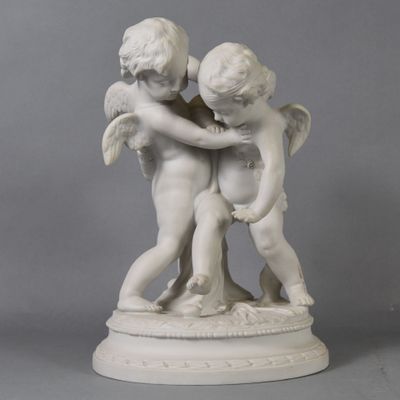 a statue of two children hugging each other on a pedestal